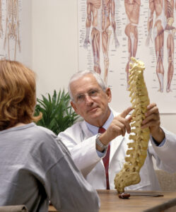 a chiropractor showing a patie